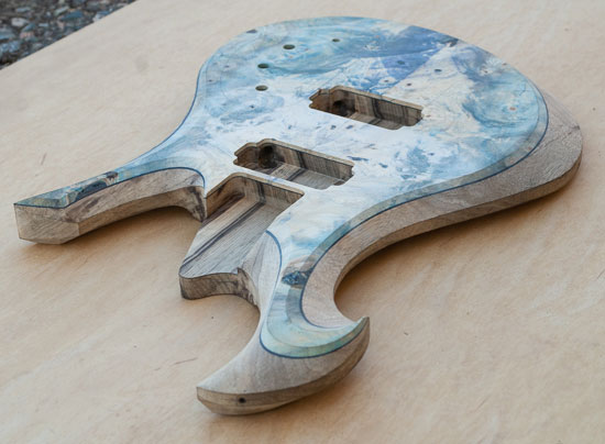 Carved exotic custom guitar body with green, yellow and purple topwood