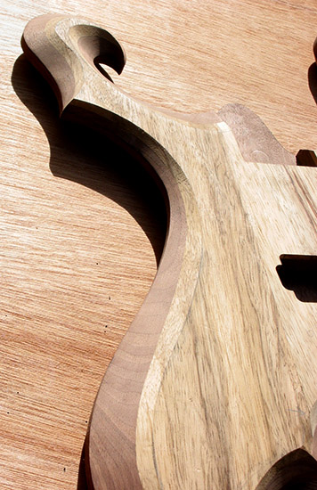 Arm bevel on a limba and black walnut metal guitar