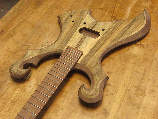 Metal style electric guitar with dual scrolls, limba and black walnut body