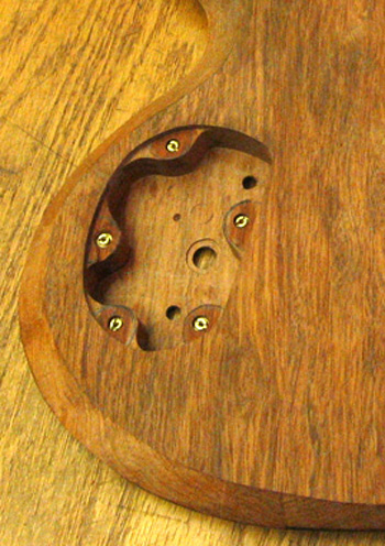 Threaded inserts in a guitar's control cavity